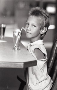 Nick as a child drinking from a straw